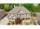 Stunning aerial view of a two-story brick home with a manicured lawn and mature trees at 2141 Abby Ne Ln, Atlanta, GA 30345