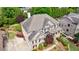 Beautiful aerial view of a brick home featuring mature landscaping, a driveway, and neighborhood views at 2141 Abby Ne Ln, Atlanta, GA 30345