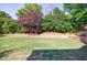 Lush backyard featuring a retaining wall, greenery, and a hot tub at 2141 Abby Ne Ln, Atlanta, GA 30345