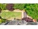 Aerial view of backyard featuring stone patio, a wooden hot tub, well-kept lawn, and mature trees at 2141 Abby Ne Ln, Atlanta, GA 30345