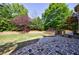 Backyard with stone patio, lush landscaping, and hot tub platform at 2141 Abby Ne Ln, Atlanta, GA 30345