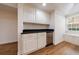 Finished basement bar area with white cabinets, dark countertops, stainless steel appliances, and window at 2141 Abby Ne Ln, Atlanta, GA 30345