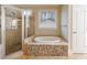 The bathroom includes a soaking tub with stone accents and separate shower with glass door at 2141 Abby Ne Ln, Atlanta, GA 30345