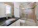 Bathroom with a granite countertop and a tiled shower and bath combo with glass doors at 2141 Abby Ne Ln, Atlanta, GA 30345