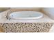 The bathroom includes a close up of a soaking tub with stone accents at 2141 Abby Ne Ln, Atlanta, GA 30345