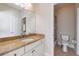 Bathroom featuring a granite countertop vanity, framed mirror, toilet, and walk-in shower at 2141 Abby Ne Ln, Atlanta, GA 30345