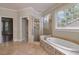 Bright bathroom featuring soaking tub with stone accents and separate shower at 2141 Abby Ne Ln, Atlanta, GA 30345