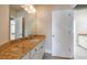 Bathroom boasts a granite countertop, white cabinets, large mirror, sconce lighting, and white doors at 2141 Abby Ne Ln, Atlanta, GA 30345