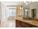 The bathroom includes a double vanity with granite countertops, tiled floors, and natural light at 2141 Abby Ne Ln, Atlanta, GA 30345