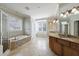Bright bathroom featuring double vanity, soaking tub with stone accents, and a separate shower at 2141 Abby Ne Ln, Atlanta, GA 30345