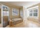 Bright bathroom featuring soaking tub with stone accents and separate shower with glass door at 2141 Abby Ne Ln, Atlanta, GA 30345