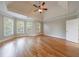 Primary bedroom featuring tray ceiling, fan, and hardwood flooring at 2141 Abby Ne Ln, Atlanta, GA 30345