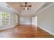Primary bedroom featuring trey ceiling, fan, hardwood flooring, and plantation shutters at 2141 Abby Ne Ln, Atlanta, GA 30345