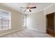 Well-lit bedroom features carpet floors, two windows, a ceiling fan, and access to an ensuite bathroom at 2141 Abby Ne Ln, Atlanta, GA 30345
