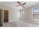 Bright bedroom with neutral paint, carpet floors, ceiling fan, and two windows with blinds for natural light at 2141 Abby Ne Ln, Atlanta, GA 30345