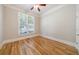 Neutral bedroom features hardwood flooring, and a window with views of exterior greenery at 2141 Abby Ne Ln, Atlanta, GA 30345