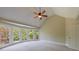 Spacious bedroom with vaulted ceiling, ceiling fan, and a large bay window overlooking the backyard at 2141 Abby Ne Ln, Atlanta, GA 30345