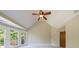 Bedroom with a vaulted ceiling, ceiling fan, carpet, and a bay window overlooking a lush green yard at 2141 Abby Ne Ln, Atlanta, GA 30345