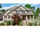 Beautiful two-story brick home with a covered front porch, manicured lawn, and mature landscaping at 2141 Abby Ne Ln, Atlanta, GA 30345