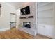 Elegant stone fireplace with TV, hardwood floors, and built-in shelves adds charm to this inviting living space at 2141 Abby Ne Ln, Atlanta, GA 30345