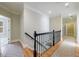Light-filled hallway features hardwood floors, elegant staircase, and access to multiple rooms in the home at 2141 Abby Ne Ln, Atlanta, GA 30345