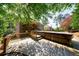 Backyard view of a wooden deck with a hot tub, surrounded by lush greenery and mature trees offering privacy and shade at 2141 Abby Ne Ln, Atlanta, GA 30345
