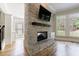 Living room boasts a stone fireplace, hardwood floors, natural light, and neutral paint at 2141 Abby Ne Ln, Atlanta, GA 30345