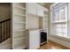Living room features a built-in bar, large window, hardwood floors, and neutral paint at 2141 Abby Ne Ln, Atlanta, GA 30345