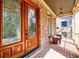 Covered porch with brick flooring, seating, and decorative glass front door at 2141 Abby Ne Ln, Atlanta, GA 30345