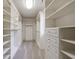 A large walk-in closet with custom white shelving, cabinets, and drawers for optimal storage and organization at 2141 Abby Ne Ln, Atlanta, GA 30345