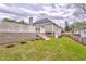 Spacious backyard featuring tiered landscaping with lush grass and retaining wall with steps to the main level at 3229 Summer Stream Nw Ln, Kennesaw, GA 30152