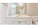 Bathroom features a white vanity, mirror and toilet, complemented by a shower visible in the reflection at 3229 Summer Stream Nw Ln, Kennesaw, GA 30152