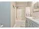 Bathroom with white shower, grey cabinets, and marble floors at 3229 Summer Stream Nw Ln, Kennesaw, GA 30152