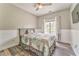 Cozy bedroom with ceiling fan, wainscoting, and natural light at 3229 Summer Stream Nw Ln, Kennesaw, GA 30152