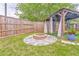Backyard retreat features a beautiful stone fire pit, gazebo, and a wooden fence for added privacy at 3229 Summer Stream Nw Ln, Kennesaw, GA 30152