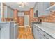 Modern kitchen featuring gray cabinets, white countertops, stainless appliances and exposed brick accent wall at 3229 Summer Stream Nw Ln, Kennesaw, GA 30152