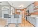Kitchen with stainless steel appliances, gray cabinetry, a brick accent wall, and bar seating at 3229 Summer Stream Nw Ln, Kennesaw, GA 30152