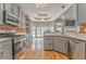 Open concept kitchen with stainless steel appliances, gray cabinets and a breakfast nook overlooking pool at 3229 Summer Stream Nw Ln, Kennesaw, GA 30152