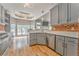 Spacious kitchen with stainless steel appliances, brick accent wall, gray cabinets, and breakfast nook at 3229 Summer Stream Nw Ln, Kennesaw, GA 30152