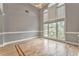 Living room featuring large windows and hardwood floors with a decorative border at 3229 Summer Stream Nw Ln, Kennesaw, GA 30152