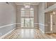 Bright living room with hardwood floors, large windows, and neutral walls, creating a welcoming and airy space at 3229 Summer Stream Nw Ln, Kennesaw, GA 30152