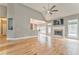 Bright living room featuring hardwood floors, a fireplace, neutral paint, and access to the kitchen at 3229 Summer Stream Nw Ln, Kennesaw, GA 30152