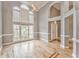 Spacious living room with hardwood floors, tall windows, and a vaulted ceiling with decorative lighting at 3229 Summer Stream Nw Ln, Kennesaw, GA 30152