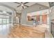 Spacious living room featuring hardwood floors, a fireplace, neutral paint, and access to the kitchen at 3229 Summer Stream Nw Ln, Kennesaw, GA 30152