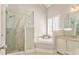 Bright bathroom featuring a glass shower, soaking tub, and neutral color palette at 3229 Summer Stream Nw Ln, Kennesaw, GA 30152