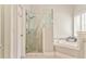 Bright bathroom featuring a glass shower, soaking tub, and neutral color palette at 3229 Summer Stream Nw Ln, Kennesaw, GA 30152