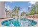 Backyard featuring a luxurious pool and slide surrounded by a fence, trees and a patio at 3229 Summer Stream Nw Ln, Kennesaw, GA 30152