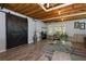 Eclectic basement featuring a sliding barn door, stylish flooring and exposed ceiling beams at 4270 Parnell Rd, Marietta, GA 30062