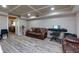 Finished basement featuring a decorative ceiling, hardwood floors, and comfortable seating at 4270 Parnell Rd, Marietta, GA 30062