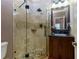 Elegant bathroom featuring a glass shower, pebble floor, and wooden vanity at 4270 Parnell Rd, Marietta, GA 30062